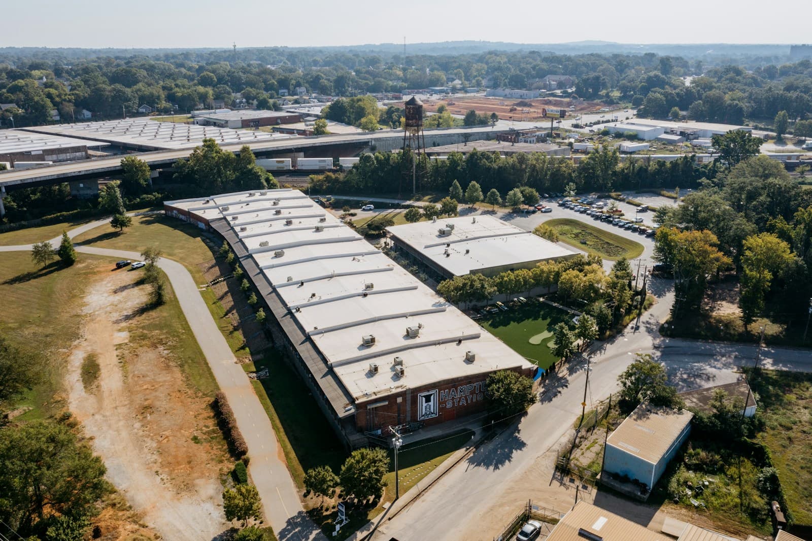 Aerial view of a large industrial building with parking lot